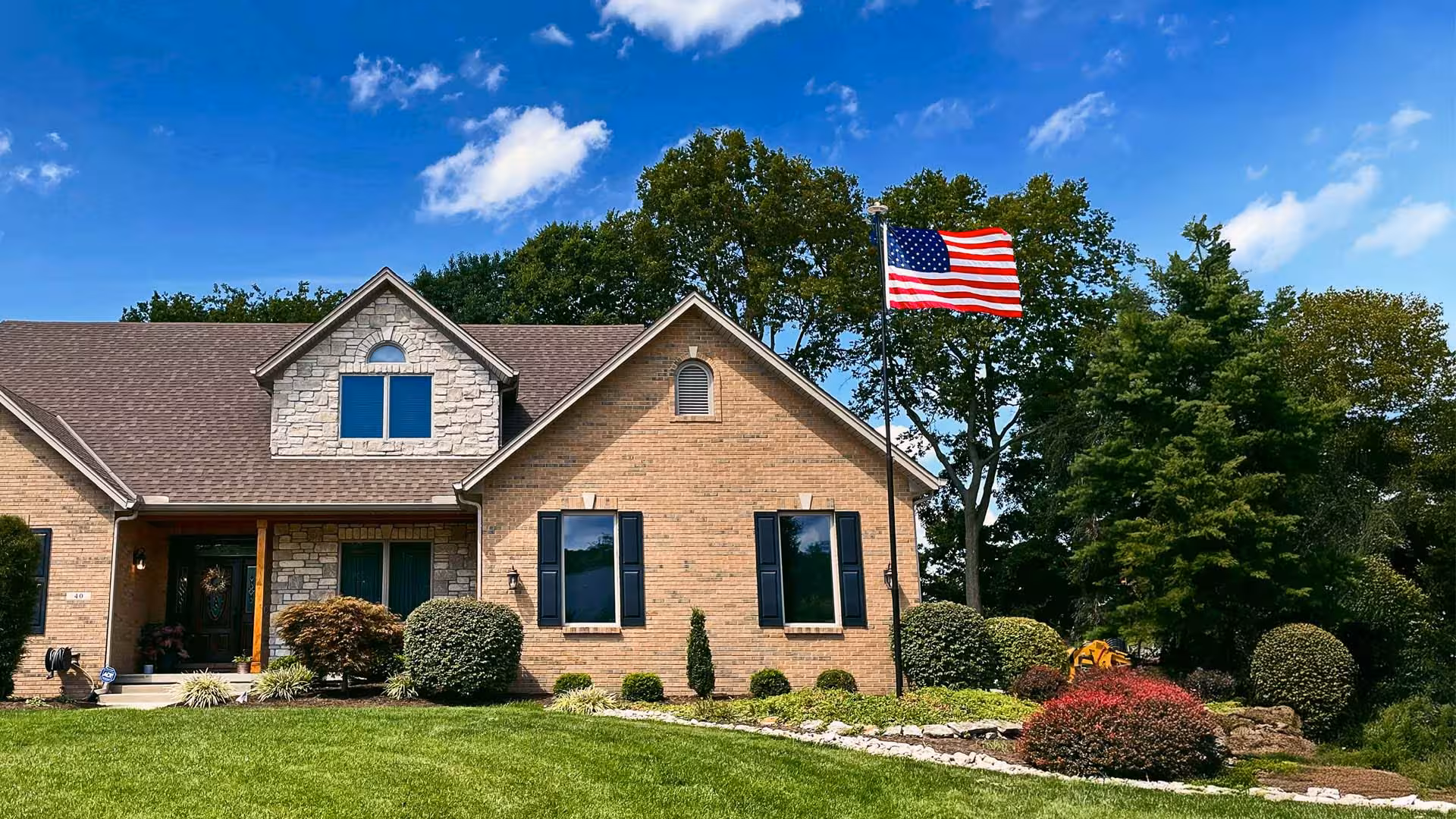 Beautiful home with American flag on premium flagpole